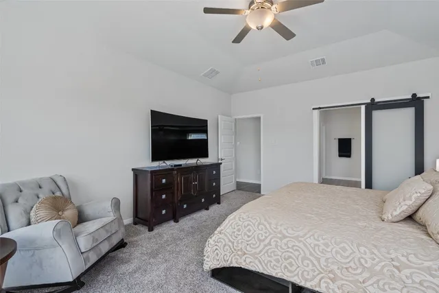 a bedroom with a bed and a television