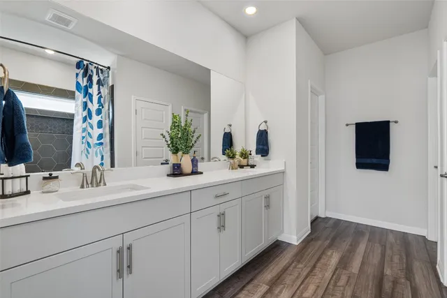 a bathroom with a double vanity sink and mirror