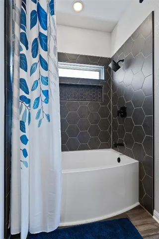 a bathroom with a bathtub and a shower