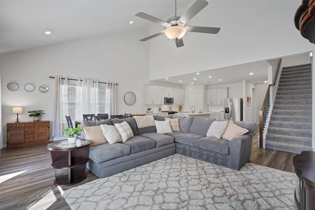 a living room with furniture and wooden floor