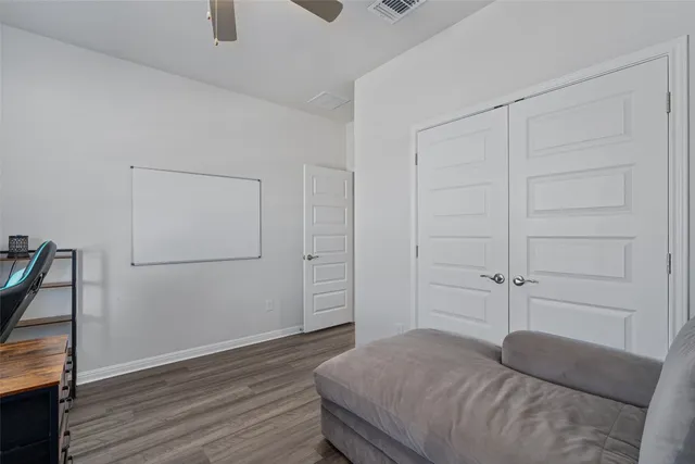 a bedroom with a bed and a cabinet