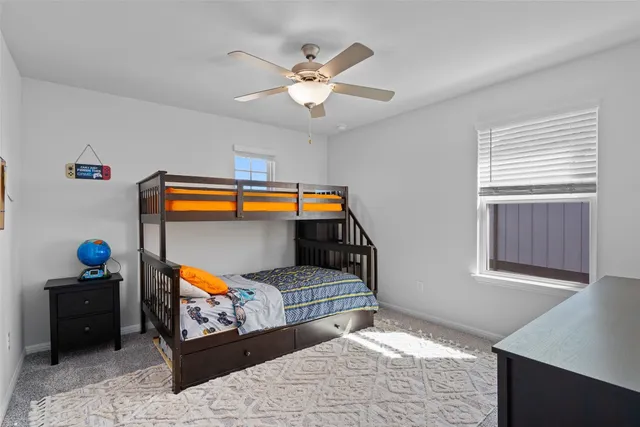 a bedroom with furniture and a mirror