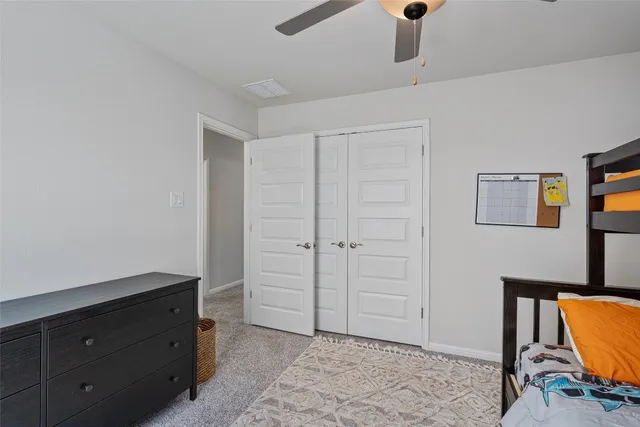 a view of room with window and ceiling fan