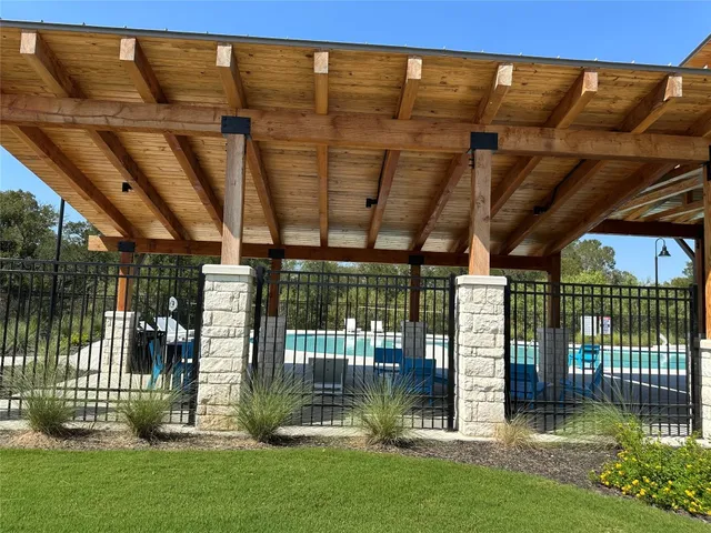 a view of a swimming pool with a patio and a garden