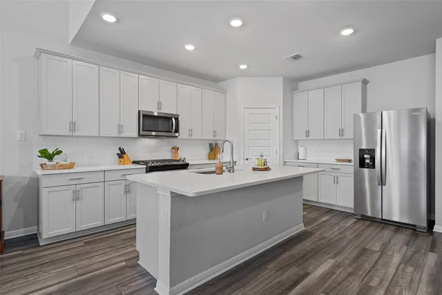a kitchen with white cabinets and white appliances