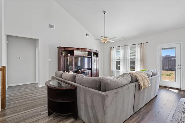 a living room with furniture and wooden floor