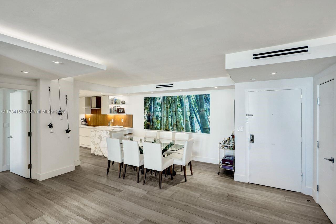 1121 Crandon Boulevard, Unit D706 Key Biscayne, FL 33149 - Photo 12 of 47 a view of a dining room with furniture window and wooden floor