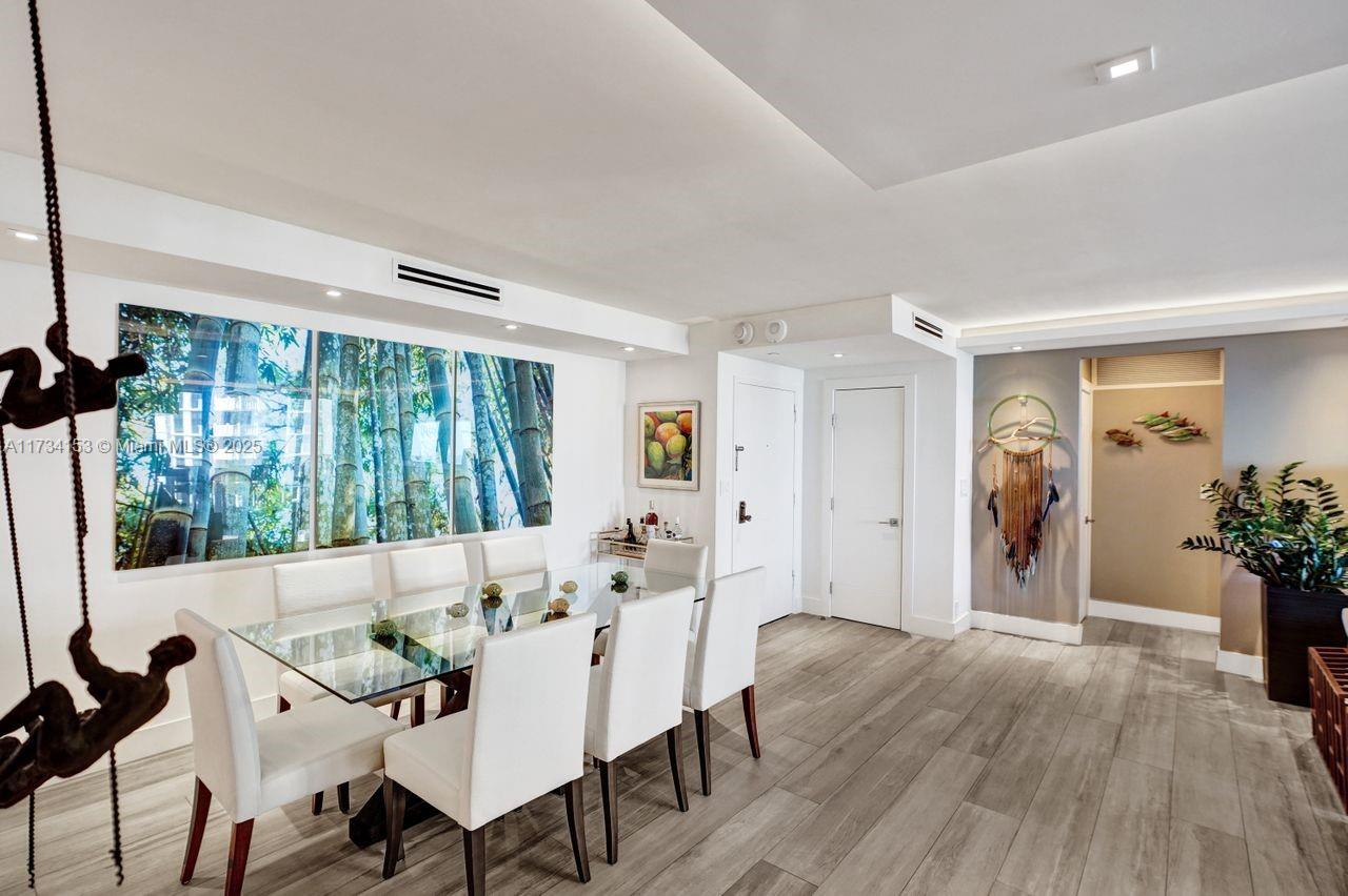 1121 Crandon Boulevard, Unit D706 Key Biscayne, FL 33149 - Photo 13 of 47 a view of a dining room with furniture window and wooden floor