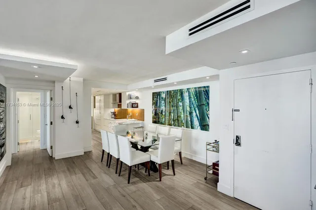 a dining room with furniture and a large window