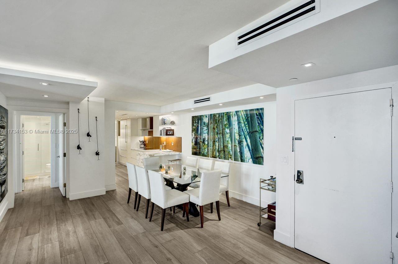 1121 Crandon Boulevard, Unit D706 Key Biscayne, FL 33149 - Photo 14 of 47 a view of a dining room with furniture window and wooden floor