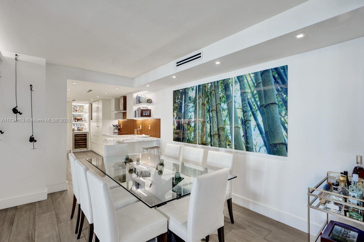 1121 Crandon Boulevard, Unit D706 Key Biscayne, FL 33149 - Photo 15 of 47 a dining room with furniture and a large window