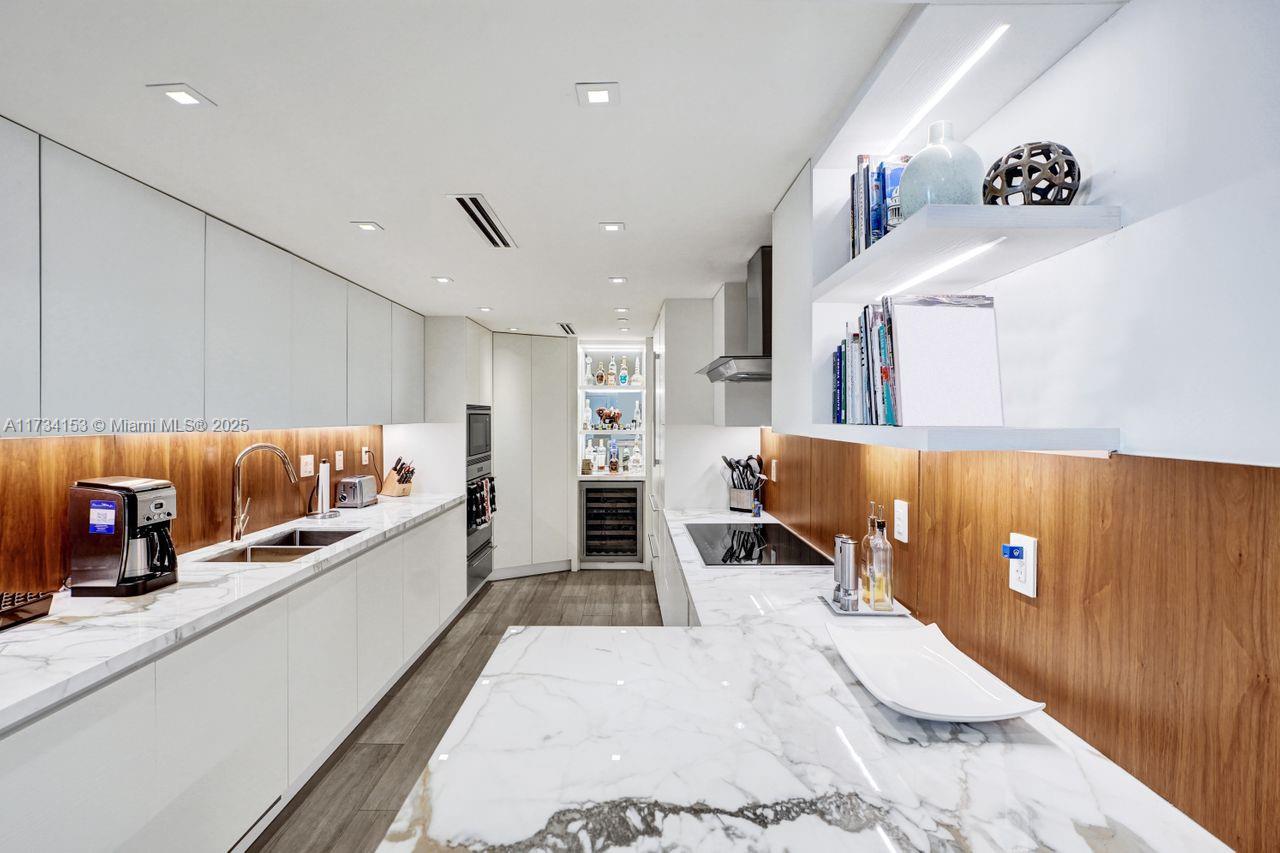 1121 Crandon Boulevard, Unit D706 Key Biscayne, FL 33149 - Photo 17 of 47 a large white room with a large bed and a couch