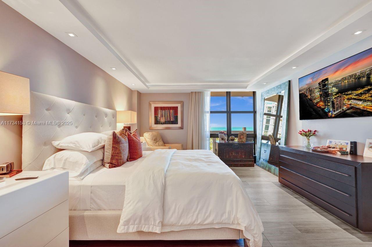 1121 Crandon Boulevard, Unit D706 Key Biscayne, FL 33149 - Photo 20 of 47 a bedroom with a large bed and a flat tv screen on dresser