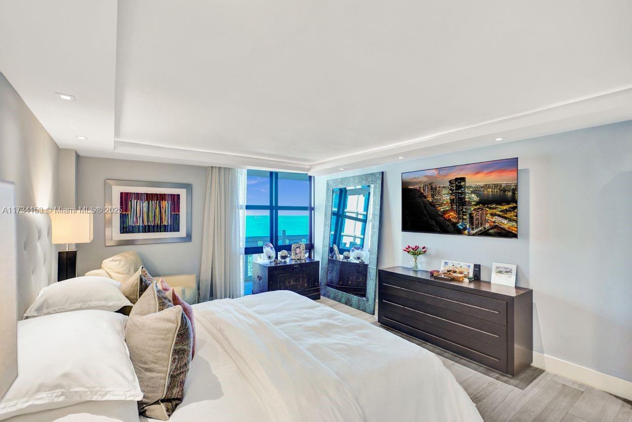 1121 Crandon Boulevard, Unit D706 Key Biscayne, FL 33149 - Photo 22 of 47 a bedroom with a bed and a flat screen tv