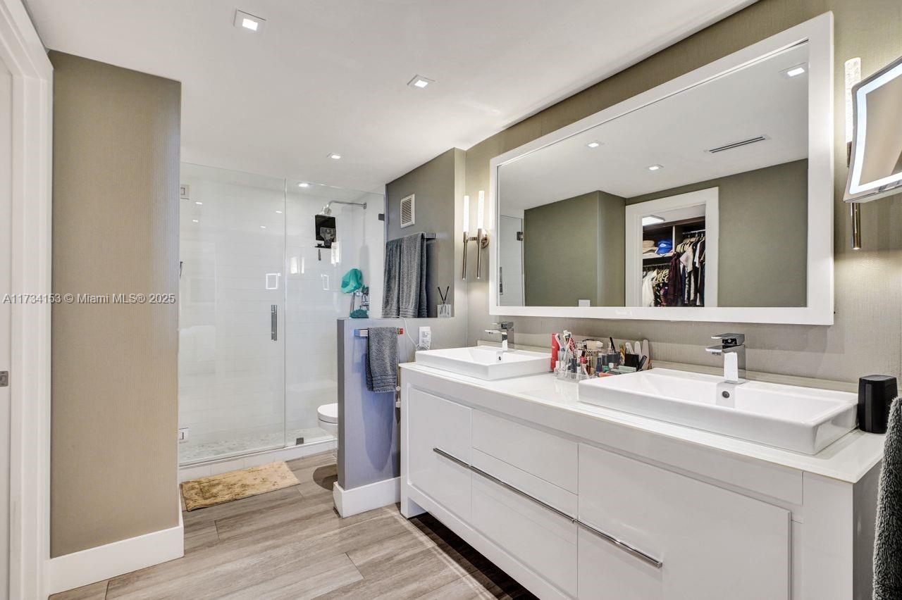 1121 Crandon Boulevard, Unit D706 Key Biscayne, FL 33149 - Photo 25 of 47 a bathroom with a double vanity sink mirror and double