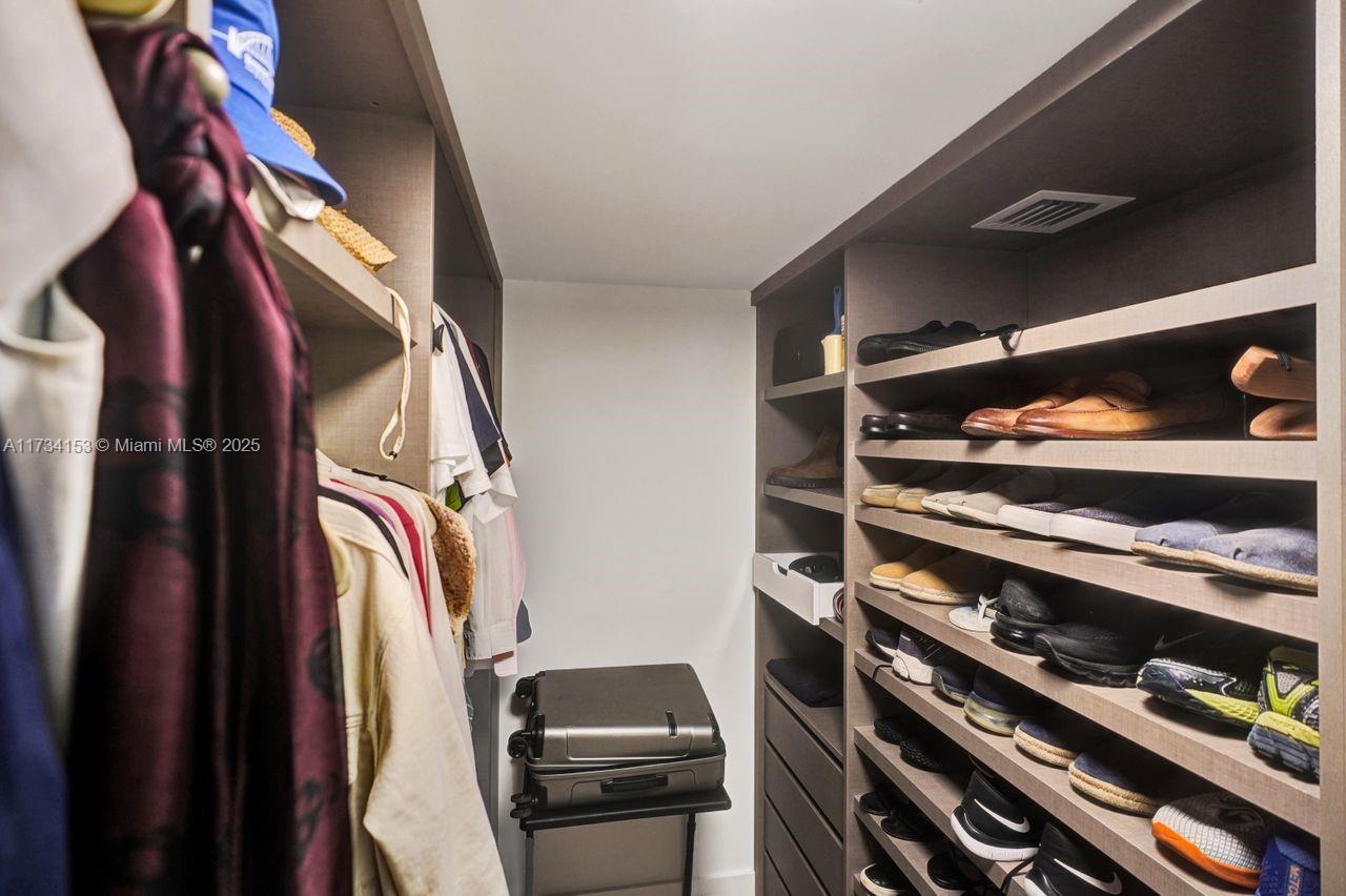 1121 Crandon Boulevard, Unit D706 Key Biscayne, FL 33149 - Photo 26 of 47 a view of walk in closet with clothes and shoes