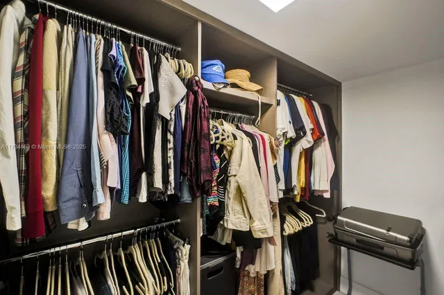 a bedroom with a bed and a view of kitchen