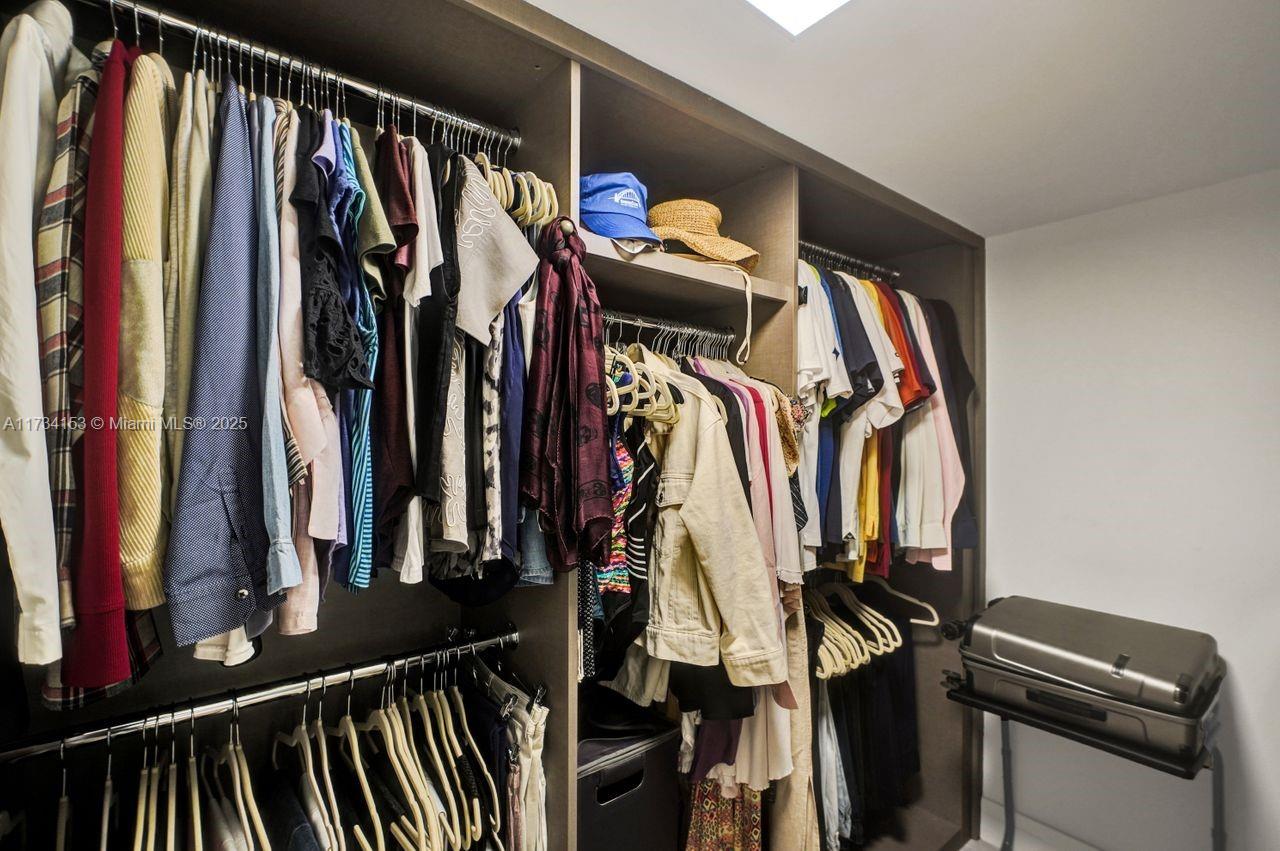1121 Crandon Boulevard, Unit D706 Key Biscayne, FL 33149 - Photo 27 of 47 a view of walk in closet with clothes and shoes