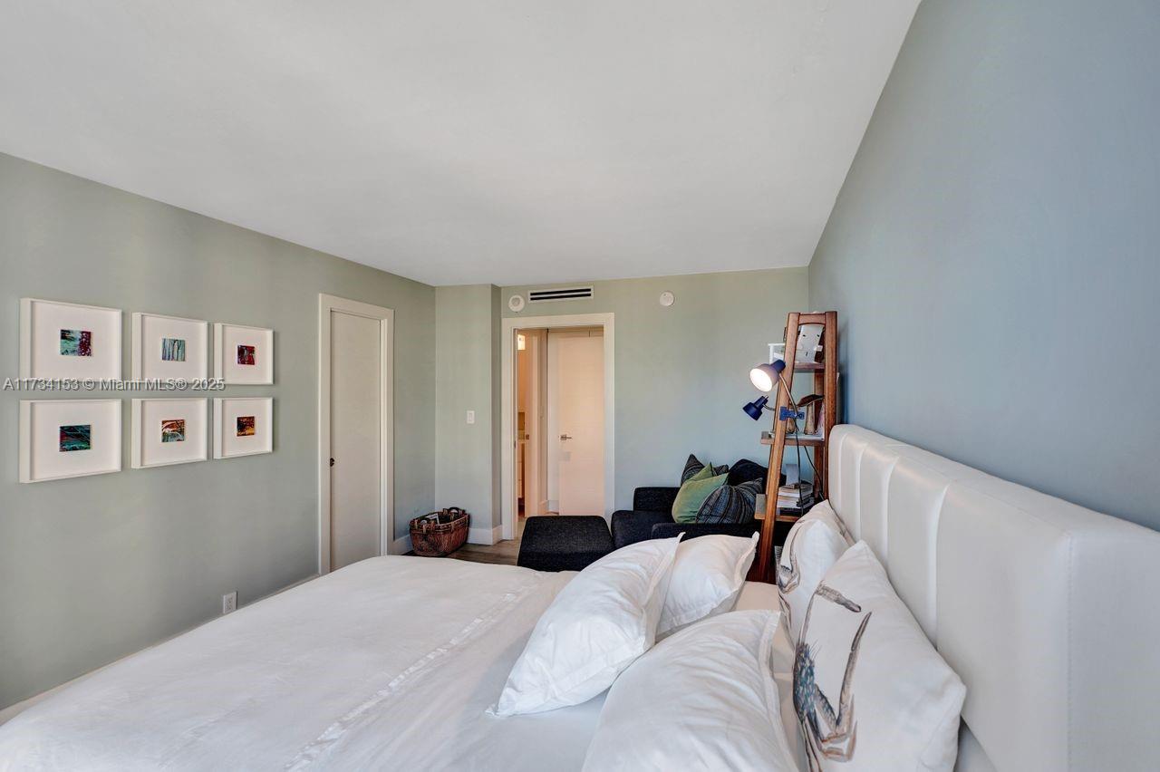 1121 Crandon Boulevard, Unit D706 Key Biscayne, FL 33149 - Photo 30 of 47 a bedroom with a bed and a couch