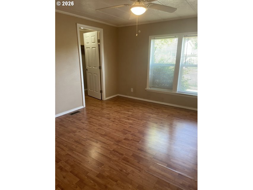 5660 Daisy Street, Unit 31 Springfield, OR 97478 - Photo 32 of 44 a view of an empty room with wooden floor and a window