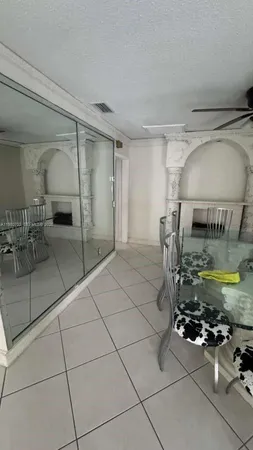 a bathroom with a granite countertop sink a toilet and mirror