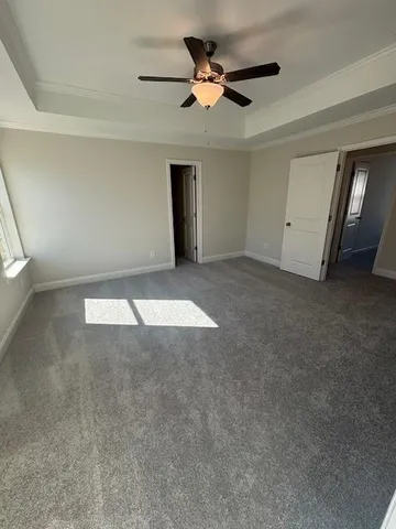 a view of an empty room with a ceiling fan