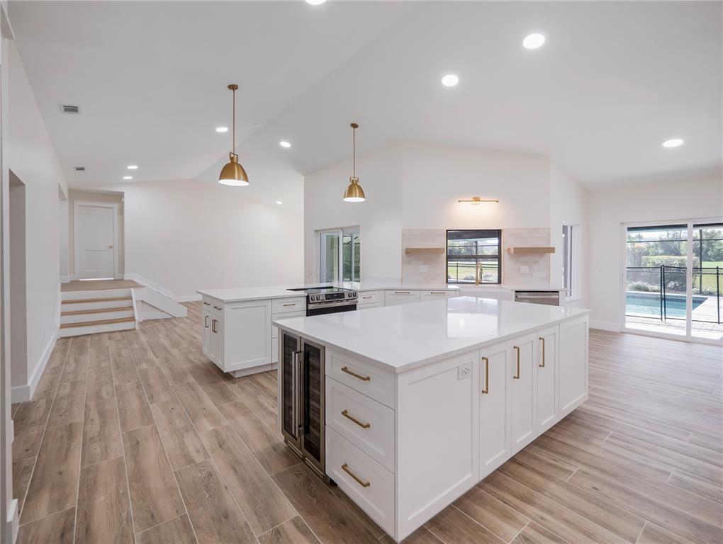 6790 Edgeworth Drive Orlando, FL 32819 - Photo 11 of 57 a kitchen with a sink and wooden floor