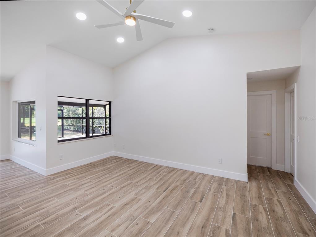 6790 Edgeworth Drive Orlando, FL 32819 - Photo 20 of 57 an empty room with wooden floor and windows