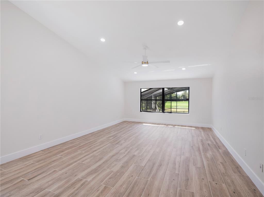 6790 Edgeworth Drive Orlando, FL 32819 - Photo 25 of 57 wooden floor in an empty room with a window