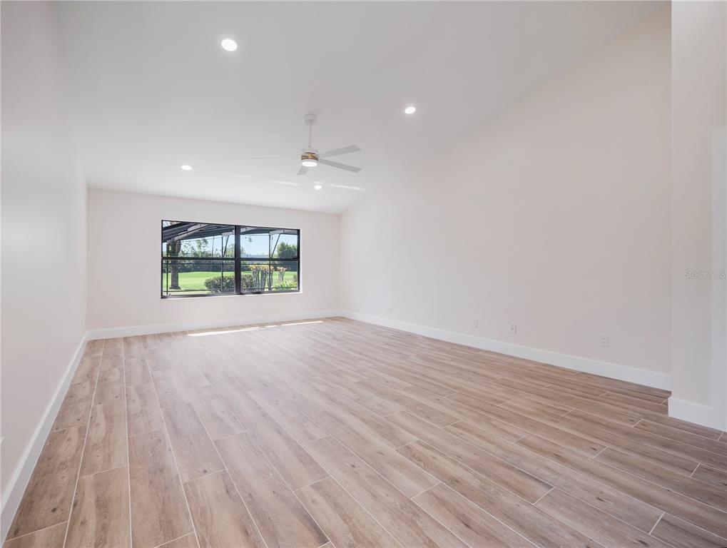 6790 Edgeworth Drive Orlando, FL 32819 - Photo 26 of 57 an empty room with wooden floor and windows