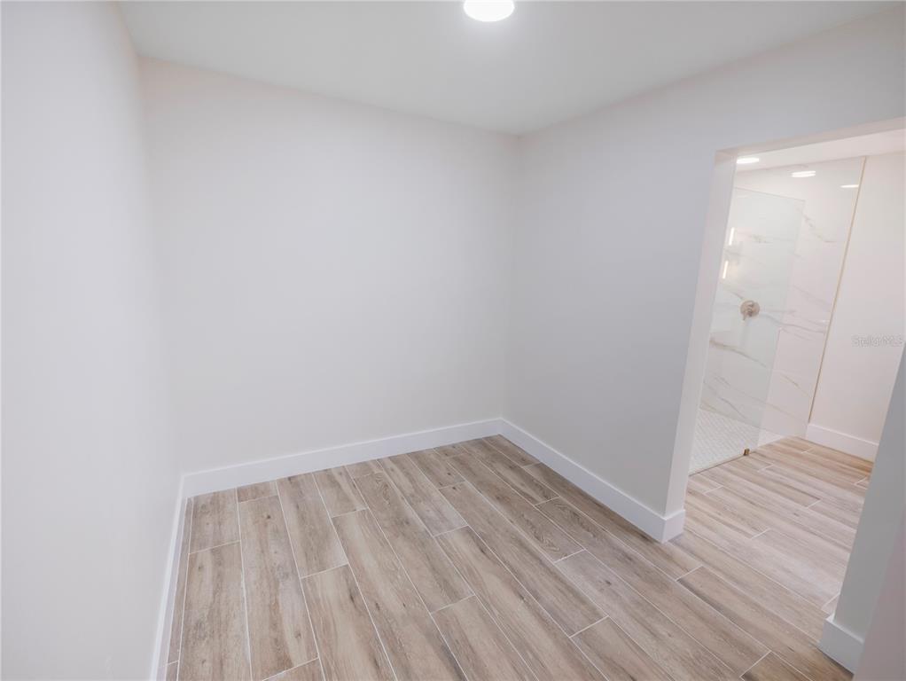 6790 Edgeworth Drive Orlando, FL 32819 - Photo 31 of 57 a view of wooden floor in a room