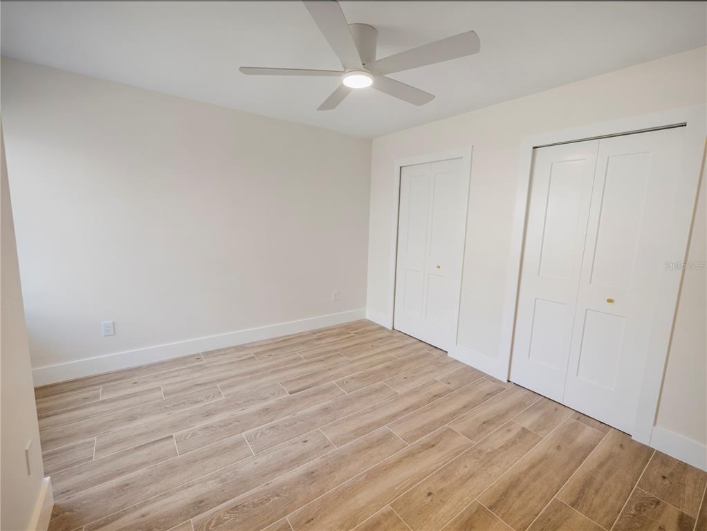 6790 Edgeworth Drive Orlando, FL 32819 - Photo 33 of 57 a view of empty room with wooden floor