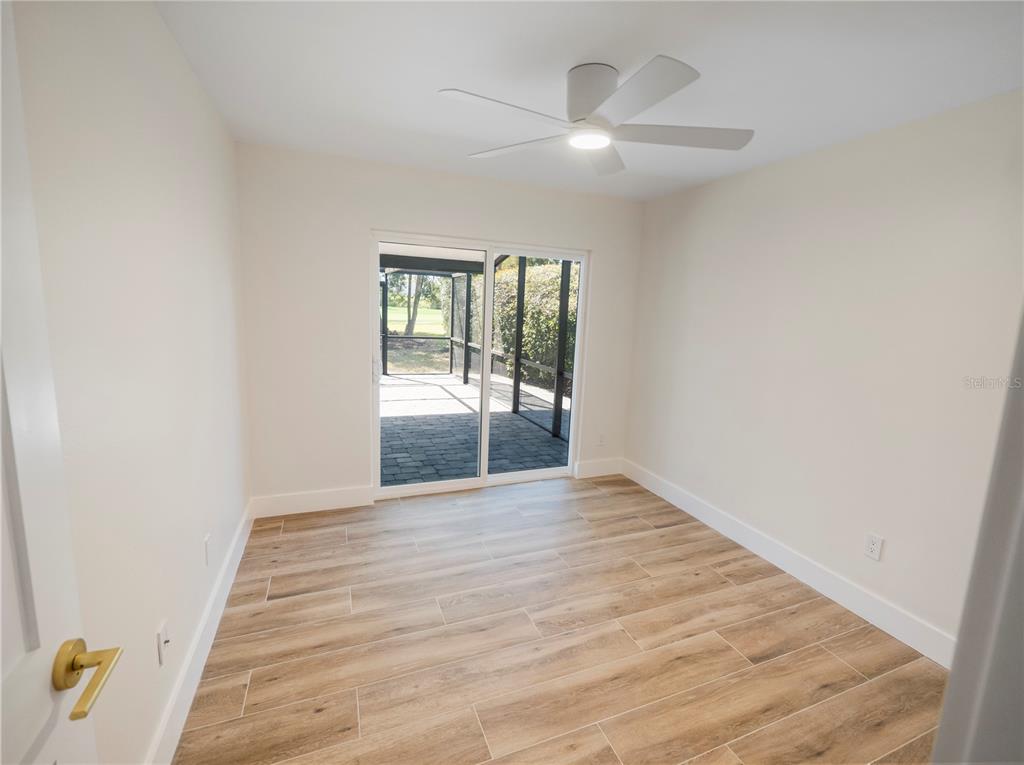 6790 Edgeworth Drive Orlando, FL 32819 - Photo 35 of 57 an empty room with wooden floor and windows