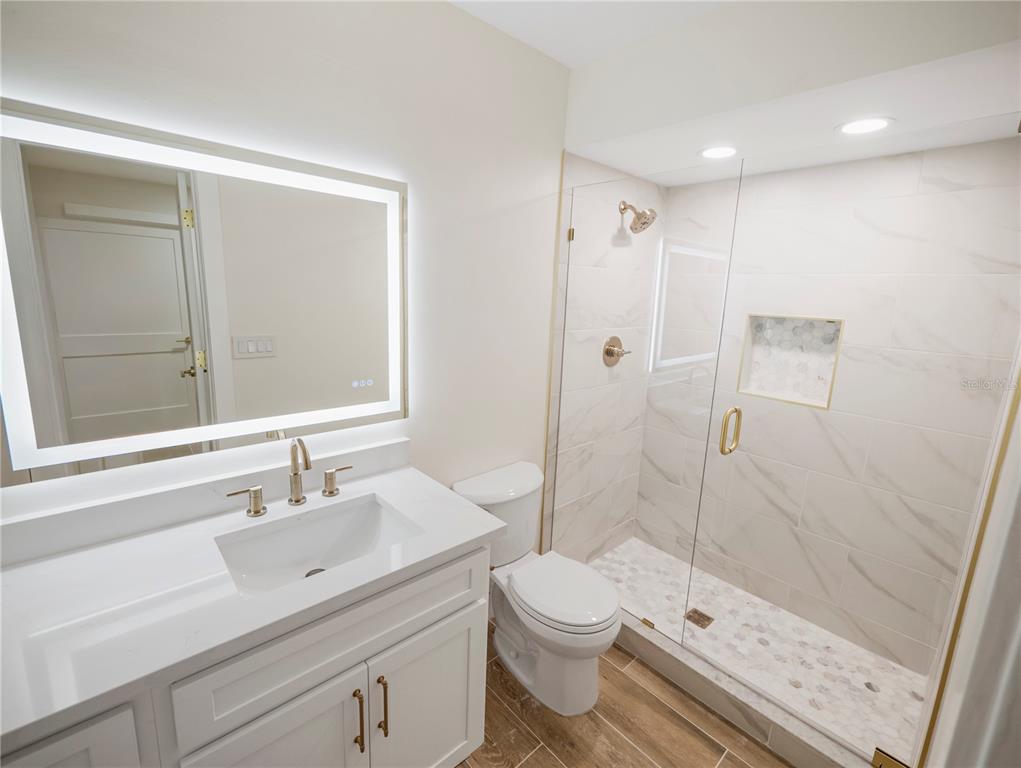 6790 Edgeworth Drive Orlando, FL 32819 - Photo 36 of 57 a bathroom with a sink a toilet and shower