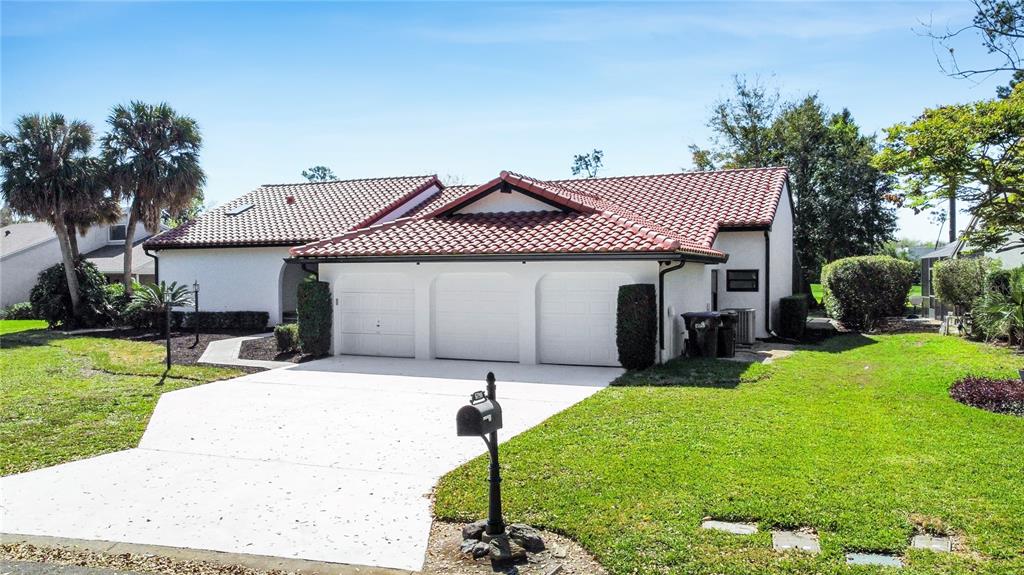 6790 Edgeworth Drive Orlando, FL 32819 - Photo 4 of 57 a front view of a house with a garden and patio