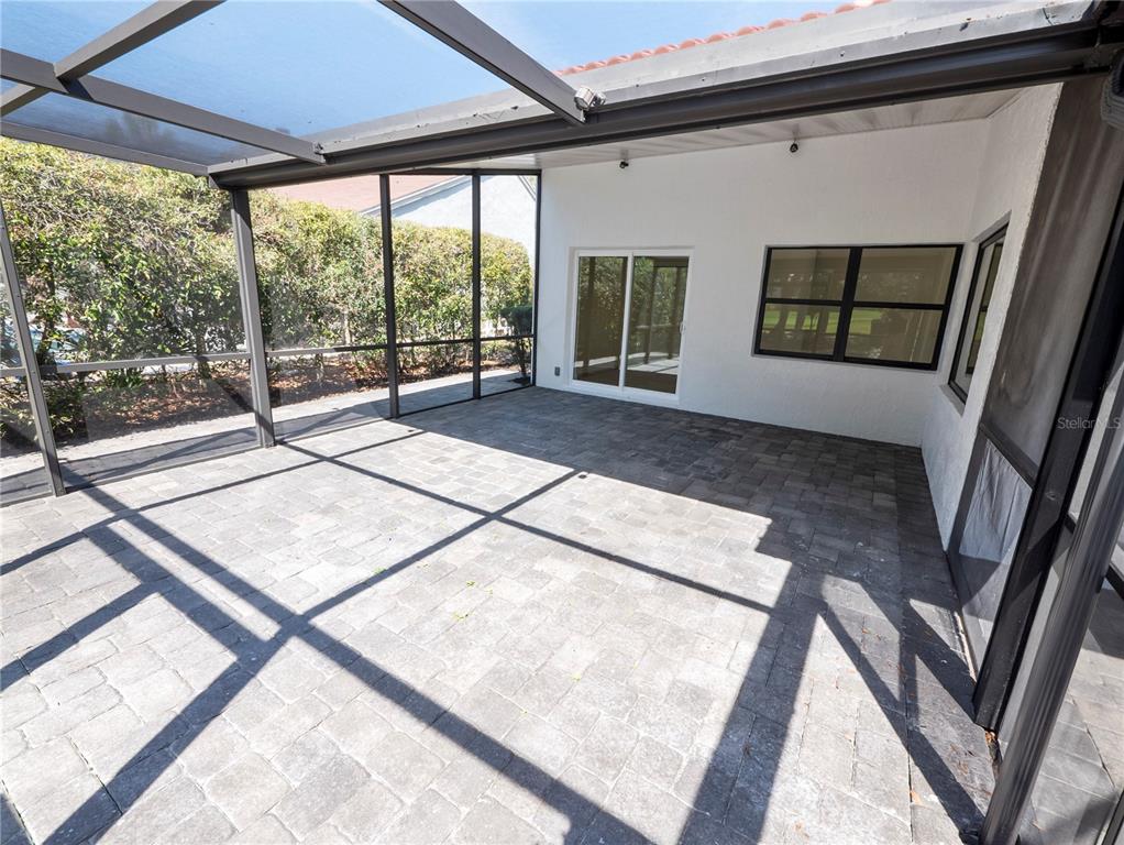 6790 Edgeworth Drive Orlando, FL 32819 - Photo 45 of 57 a living room with a large window and way to the wall