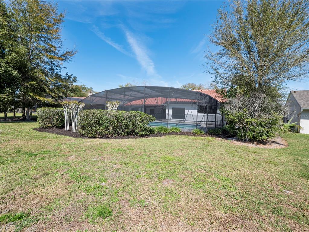 6790 Edgeworth Drive Orlando, FL 32819 - Photo 49 of 57 a front view of a house with yard and tree