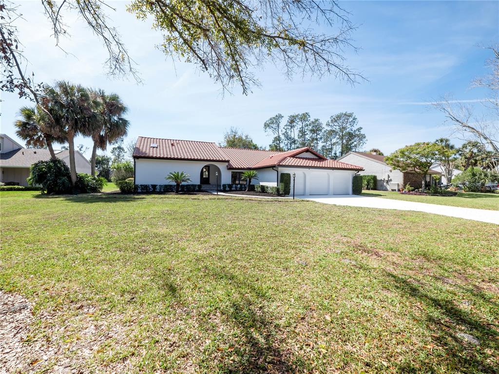 6790 Edgeworth Drive Orlando, FL 32819 - Photo 5 of 57 a front view of house with yard and green space
