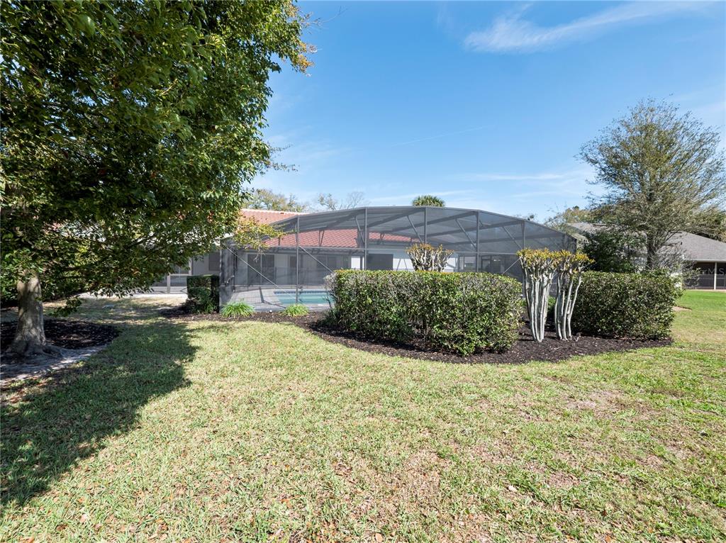 6790 Edgeworth Drive Orlando, FL 32819 - Photo 51 of 57 a view of a garden with a fountain