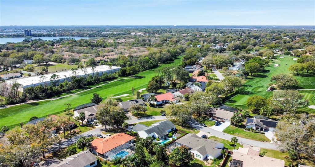 6790 Edgeworth Drive Orlando, FL 32819 - Photo 55 of 57 an aerial view of a city with lots of residential buildings