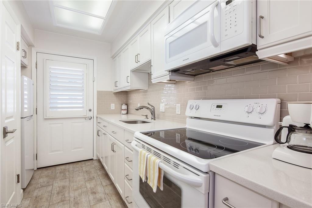 72 7th Street South, Unit 208 Naples, FL 34102 - Photo 6 of 10 a view of a kitchen with white cabinets
