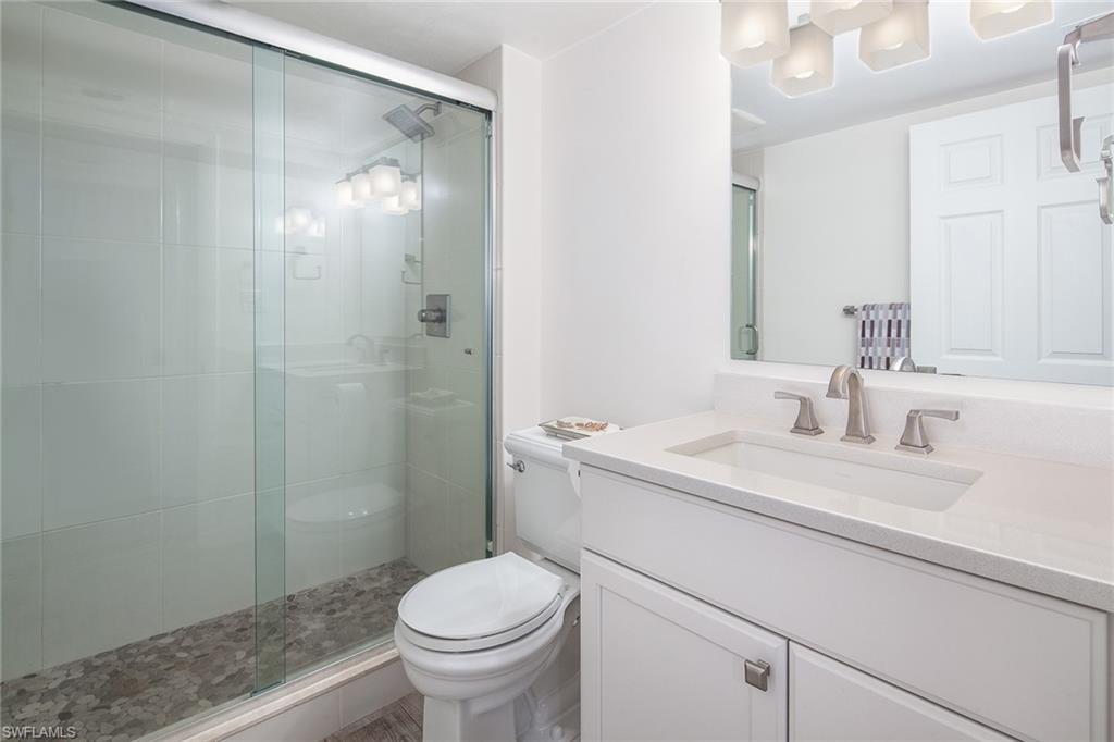 72 7th Street South, Unit 208 Naples, FL 34102 - Photo 8 of 10 a bathroom with a sink a toilet and shower