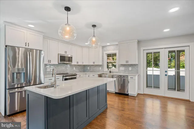a kitchen with granite countertop a sink a stove and microwave