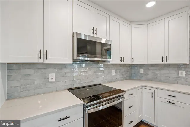 a kitchen that has a sink and a stove in it