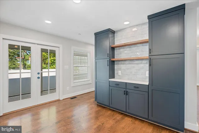 a view of hallway with a large window and wooden floor