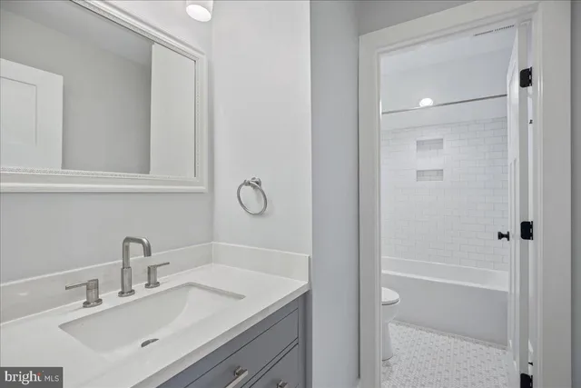 a white bath tub sitting next to a white toilet