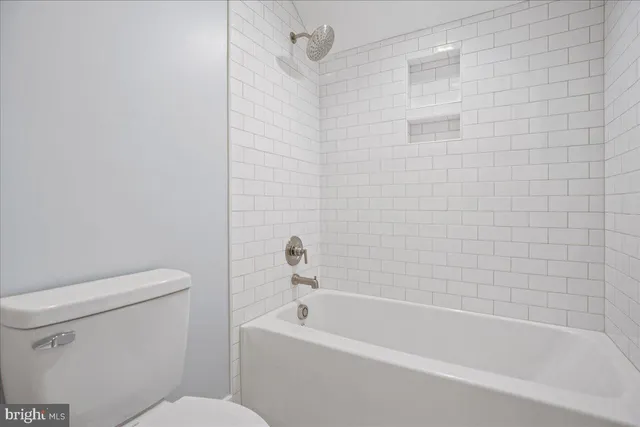 a spacious bedroom with a bed and a window