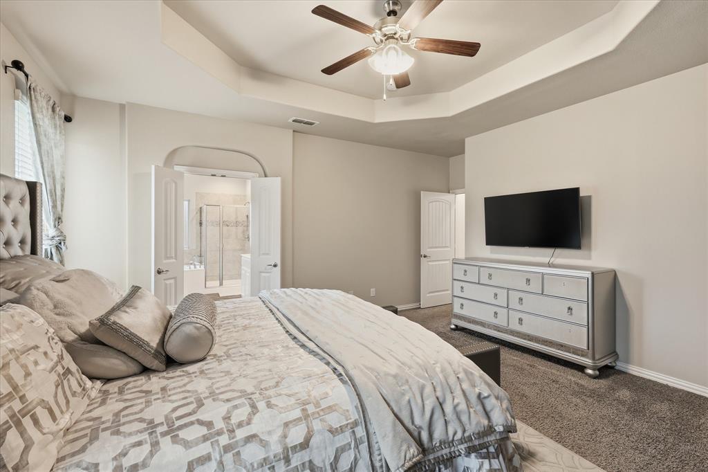 215 Equestrian Road Hickory Creek, TX 75065 - Photo 25 of 36 a bedroom with a bed and a flat screen tv
