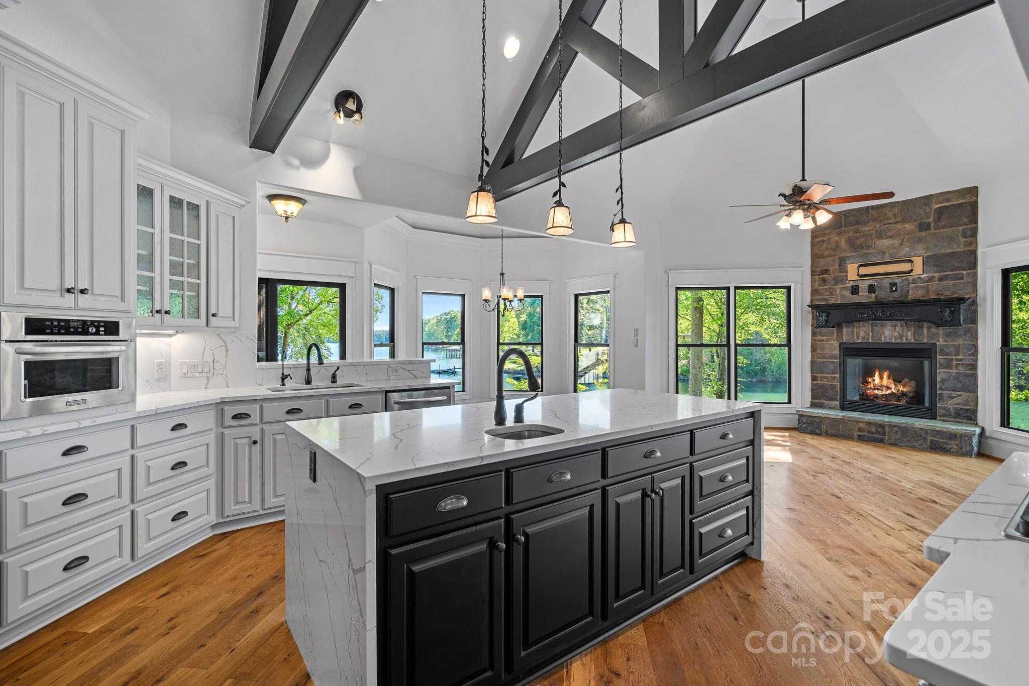 4786 Heather Lane Denver, NC 28037 - Photo 15 of 48 a kitchen with kitchen island granite countertop a sink cabinets and window