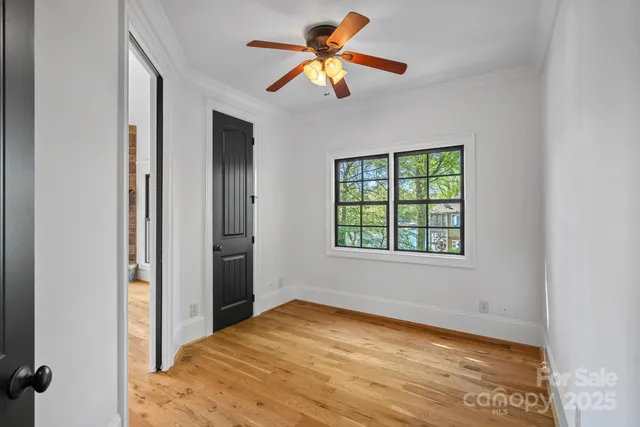 a spacious bedroom with a large bed and a flat screen tv